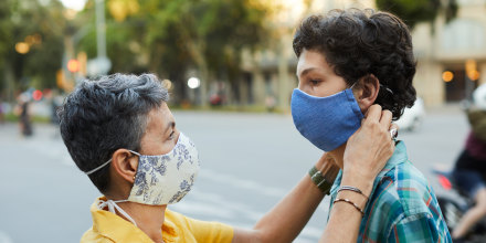 A caring mother is adjusting her teenager son's COVID mask, Shop the best masks to wear for comfort and breathability, according to doctors. Healthcare professionals share their favorite face masks to wear while off-duty.