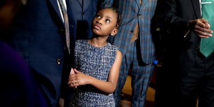Gianna Floyd, George Floyd's daughter, looks on as Philonise Floyd, George Floyd's brother, and Ben Crump, attorney representing George Floyd's family, speak to members of the media in Washington on May 25, 2021