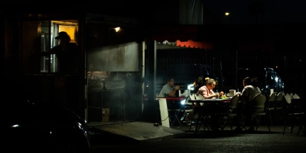 Image: Customers eat in the outdoor dining area of a restaurant in Phoenix on April 22, 2021.