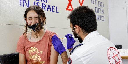 Image: An Israeli girl receives a dose of the Pfizer/BioNTech Covid-19 vaccine from the Magen David Adom during a campaign by the Tel Aviv-Yafo Municipality to encourage the vaccination of teenagers