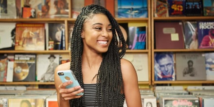 Laughing college student with phone