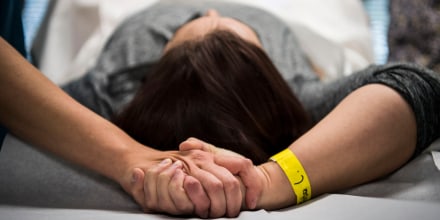 An abortion doula holds hands with a patient during an abortion procedure at an abortion clinic in Falls Church, Va., on Nov. 24, 2017.