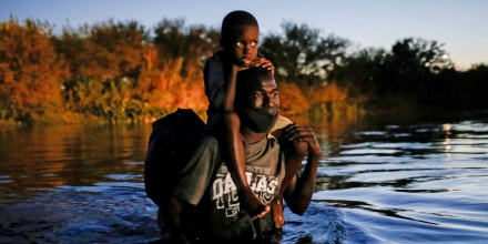 A migrant seeking refuge in the U.S. crosses the Rio Grande towards Del Rio, Texas, on Sept. 23, 2021.