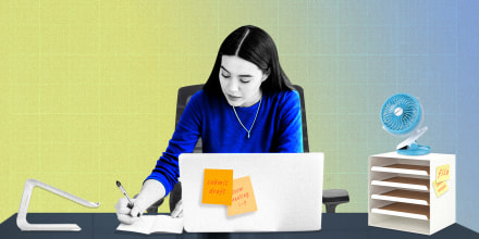 Illustration of a Woman sitting at her desk in a Branch Ergonomic Chair, writing in her notebook, surrounded by the IKEA KVISSLE Letter Tray and SkyGenius Clip-On Mini Desk Fan