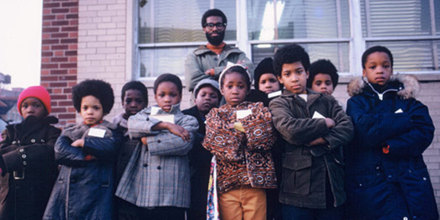 Uhuru Sasa Shule kids posing outside the school.