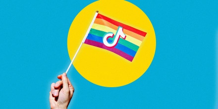 Photo illustration of a rainbow Pride flag with the TikTok logo.