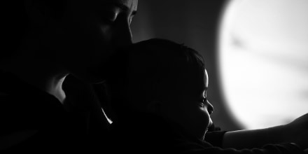 Close-Up Of Mother With Son In Darkroom