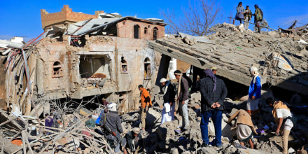 Image: Yemenis inspect the damage following overnight air strikes by the Saudi-led coalition targeting the Huthi rebel-held capital Sanaa, on Jan. 18, 2022.