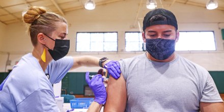Nurse practitioner Dawn Kaiser administers a COVID-19 vaccination