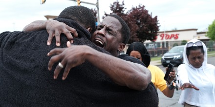 Image: Evangelist Bruce Warrick performs a baptism outside of Tops grocery store, in Buffalo, N.Y., on May 20, 2022.