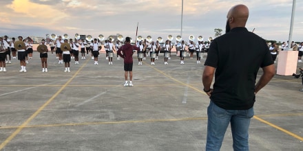 Image: Trymaine Lee watches the marching band at Texas Southern University.