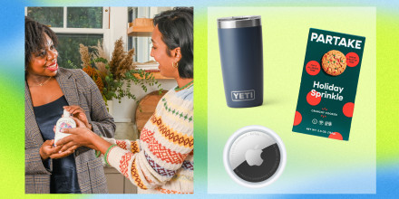 Two Women giving gifts to each other, and apple air tag, a yeti tumbler and a box of cookies