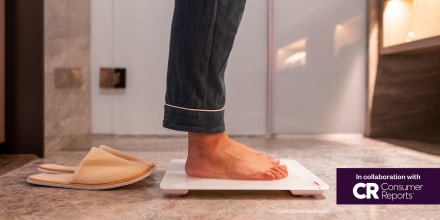 Low Section Of woman Standing On Weight Scale