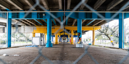 The area below the Claiborne interstate is blocked off with chain link fence in New Orleans