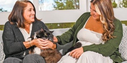 Two woman outside with a cat