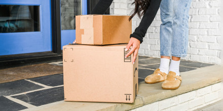 Woman picking up boxes