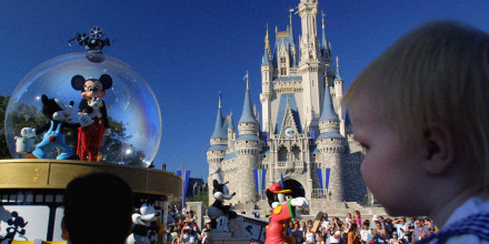 Image: Mickey Mouse rides through Main Street near Cinderella's castle at Disney World in 2001.