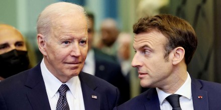 President Joe Biden speaks with France's President Emmanuel Macron ahead of an extraordinary NATO summit at NATO Headquarters in Brussels on March 24.