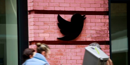 People walk by the Twitter office on April 26 in New York City