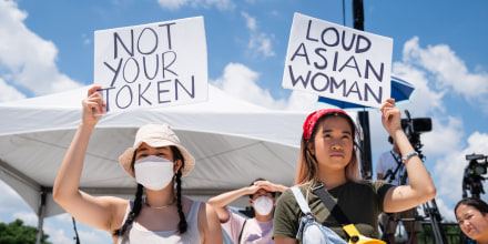 Demonstrators hold signs during the Unity March rally