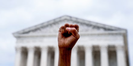 An abortion rights activist stands outside the Supreme Court on June 24, 2022.