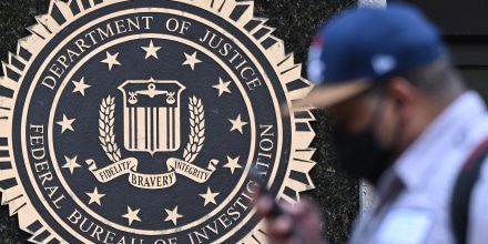 A pedestrian walks past the J. Edgar Hoover FBI building, in Washington, D.C. on August 15.