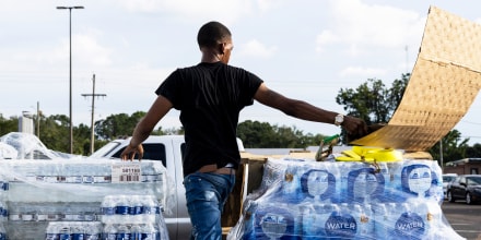 Cases of bottled water are handed out at a Mississippi Rapid Response Coalition distribution site