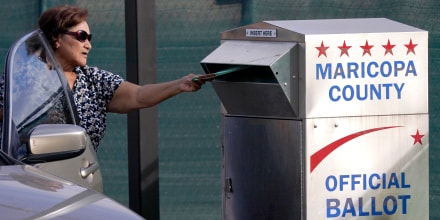 A voter casts their ballot at a secure ballot drop box at the Maricopa County Tabulation and Election Center in Phoenix, on Nov. 1, 2022.