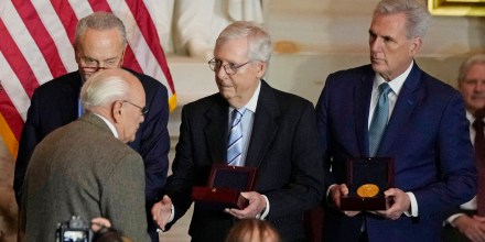 Senate Minority Leader Mitch McConnell reaches out to shake the hand of Charles Sicknick, father of slain Capitol Police Officer Brian Sicknick, during a Congressional Gold Medal ceremony on Dec. 6, 2022. 