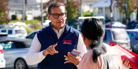 Congressman-elect George Santos talks to a voter while campaigning