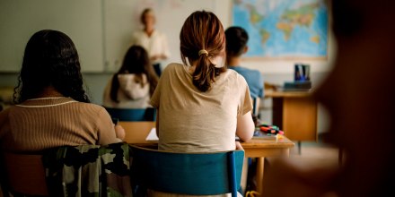 Teenage girls and boys learning in classroom