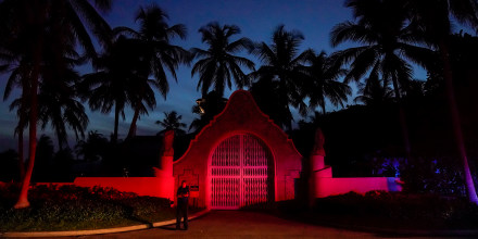 A man stands outside an entrance to former President Donald Trump's Mar-a-Lago estate, on Aug. 8, 2022, in Palm Beach, Fla.