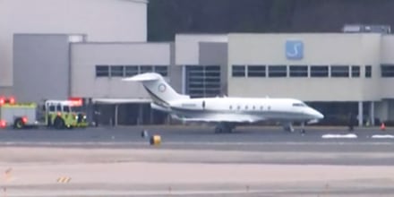 An emergency vehicle is parked near the Bombardier Challenger 300 that diverted to Bradley International Airport in Windsor Locks, Conn., on March 3, 2023.