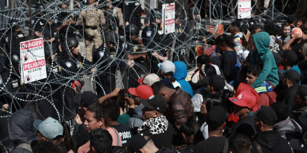 Hundreds of migrants rush the border checkpoint in Mexico