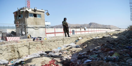 TOPSHOT - A Taliban fighter stands guard at the site of the August 26 twin suicide bombs, which killed scores of people including 13 US troops, at Kabul airport on August 27, 2021.