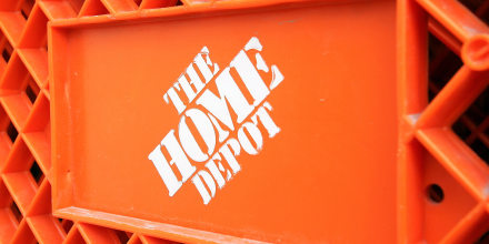 The Home Depot logo is seen on a shopping cart outside the store.