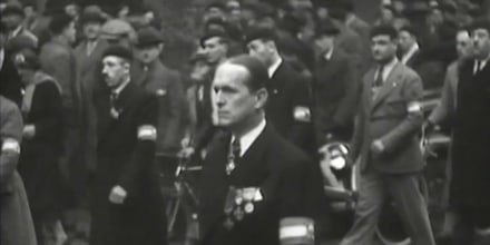 A frame from a newsreel shows Colonel François de la Roque marching with members of the Croix de Feu.