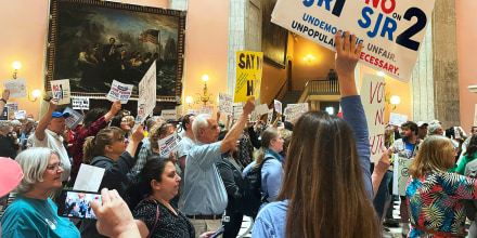 Supporters and opponents of Issue 1 rally at the statehouse rotunda in Columbus, Ohio