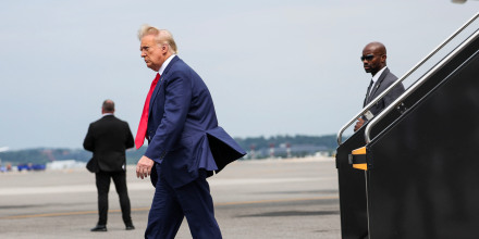 Former president Donald Trump arrives at Ronald Reagan Washington National Airport in Arlington, Va., on Aug. 3, 2023.