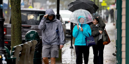 People walk in the rain and wind from storm Lee in Bar Harbor, Maine