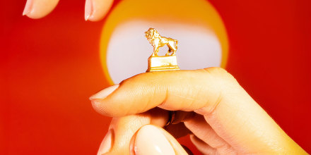 Photo of a hand holding small lion symbolizing leo 2024.
