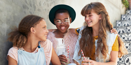 Girls sitting on staircase & chatting with lemonade