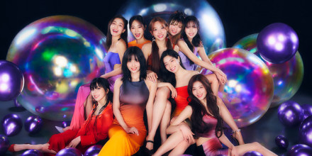 Bright photo shoot with TWICE members posing with giant and small shaped balloons on a dark background