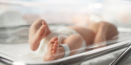 Newborn Baby Lying in Bassinet in a Maternity Hospital.