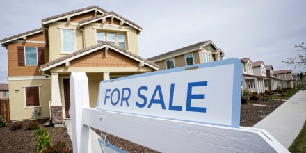 A for sale sign is posted in front of a home