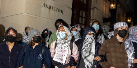 Students and demonstrators lock arms to guard potential authorities against reaching fellow protestors who barricaded themselves inside Hamilton Hall t Columbia University in New York City