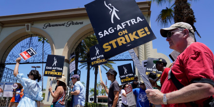 Striking writers and actors picket outside Paramount studios in Los Angeles