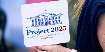 Kristen Eichamer holds a Project 2025 fan at the Iowa State Fair, in Des Moines, Iowa on Aug. 14, 2023.