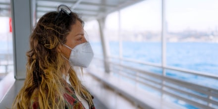 Woman with protective face mask on the ferry