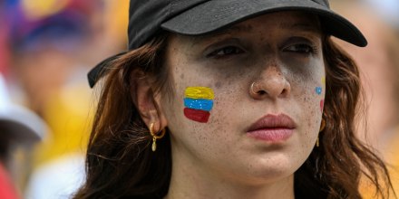 A demonstrator with a Venezuelan flag on her face at a protest against Venezuela's electoral process in Miami on Aug. 3, 2024. 
